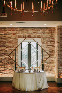 Wedding Sweetheart Table with Gold Geometric Arch Backdrop and Mr and Mrs Tabletop Signs