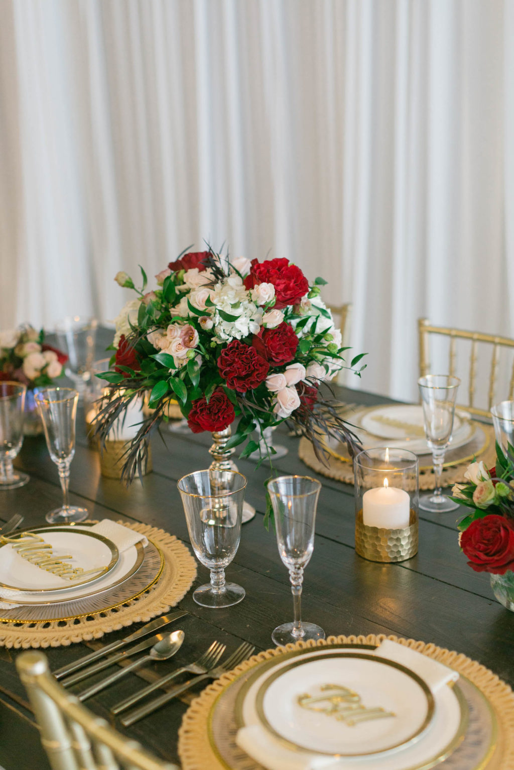 Romantic Red Low Centerpieces with Gold Chargers and Personalized Name Cards Styled with Love Influencer Wedding | St. Pete Beach Wedding Venue Bellwether Beach Resort