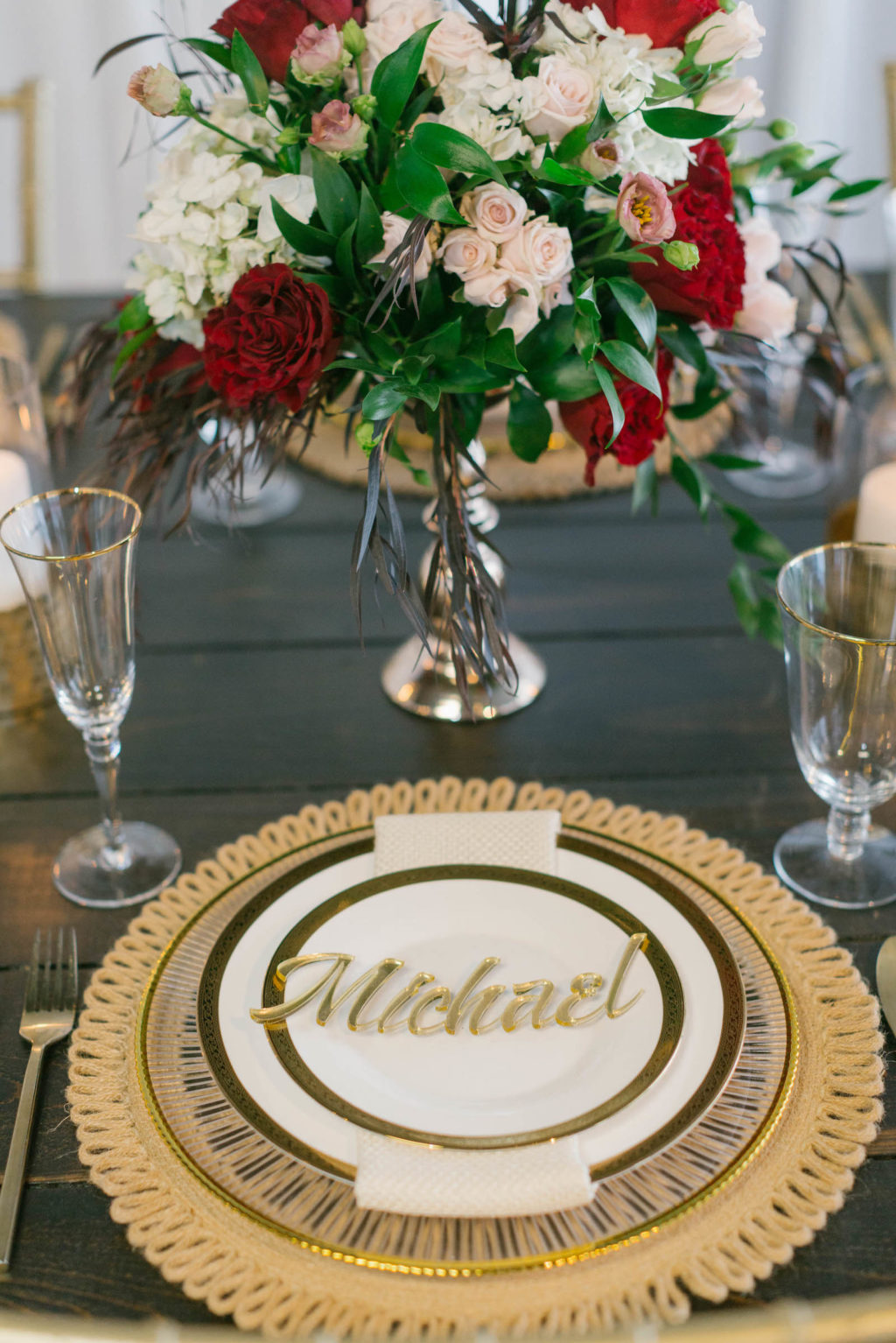 Romantic Red Low Centerpieces with Gold Chargers and Personalized Acrylic Die Cut Name Cards Styled with Love Influencer Wedding | St. Pete Beach Wedding Venue Bellwether Beach Resort