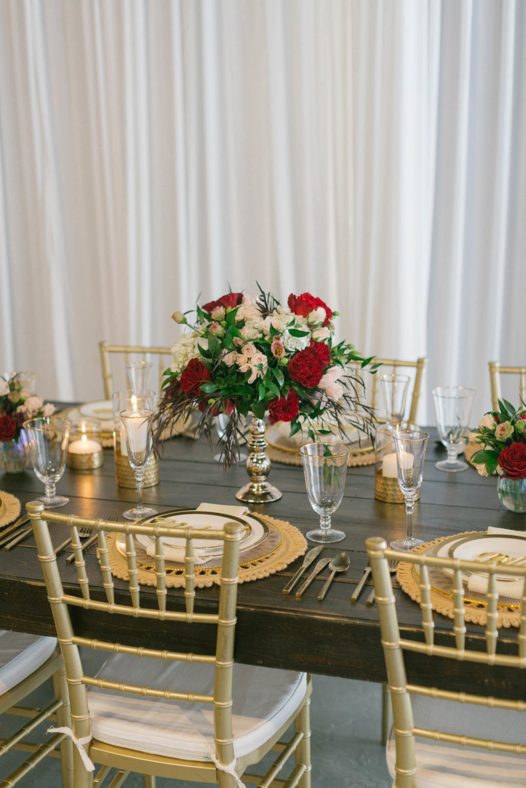 Romantic Red Low Centerpieces with Gold Chargers and Personalized Name Cards Styled with Love Influencer Wedding | St. Pete Beach Wedding Venue Bellwether Beach Resort