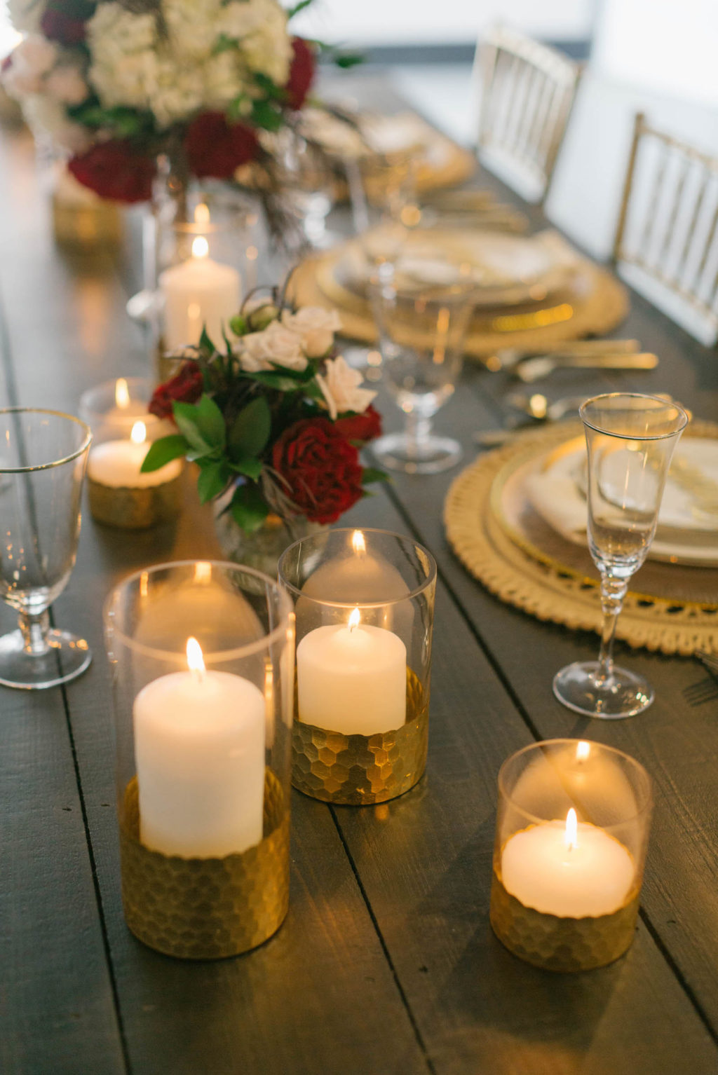Romantic Red Low Centerpieces with Gold Chargers and Candles Styled with Love Influencer Wedding | St. Pete Beach Wedding Venue Bellwether Beach Resort
