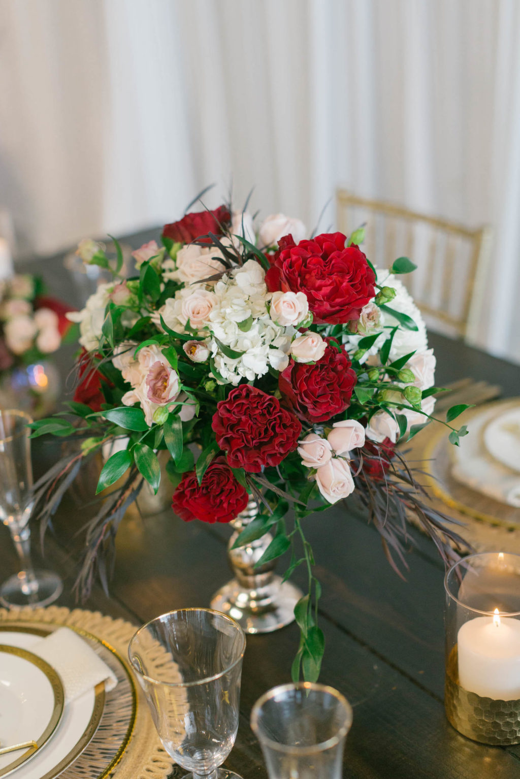 Romantic Red Low Centerpieces with Gold Chargers and Personalized Name Cards Styled with Love Influencer Wedding | St. Pete Beach Wedding Venue Bellwether Beach Resort