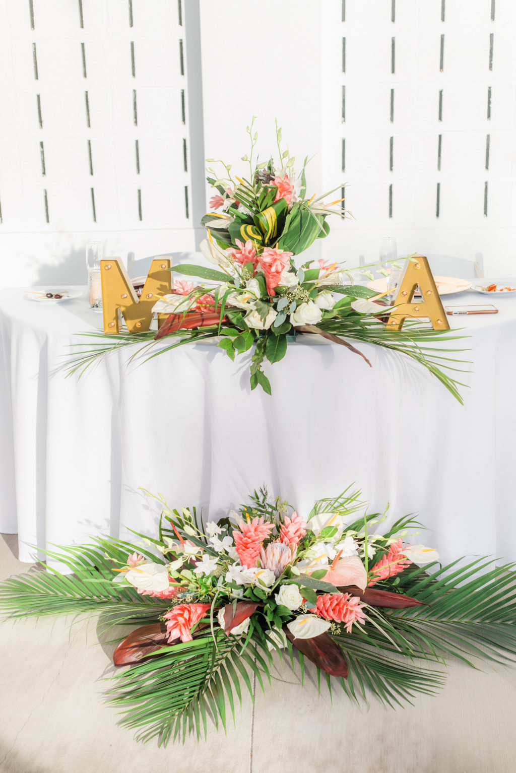 Elegant Tropical Wedding Reception Decor, Sweetheart Table with Gold Individual Letters, Floral Arrangements, Pink Ginger, Palm Fronds, White Orchids and Anthuriums | Tampa Bay Wedding Florist Iza's Flowers