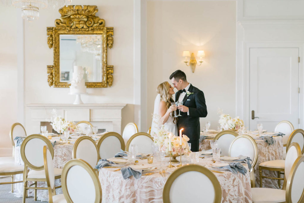 Classic Bride and Groom Cheering, Wedding Reception Decor, Round Tables with Floral Lace Table Linen and Blush Pink Underlay, Brown and White Dining Chairs | Tampa Bay Wedding Planner Parties A'la Carte | Wedding Rentals Kate Ryan Event Rentals | Bradenton Wedding Venue Concession Golf Club