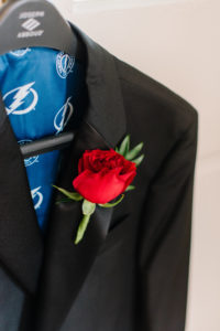 Custom Groom Tuxedo Jacket with Tampa Bay Lightning Lining and Red Rose Flower Boutonniere | Tampa Bay Wedding Florist Brides N' Blooms Wholesale Designs