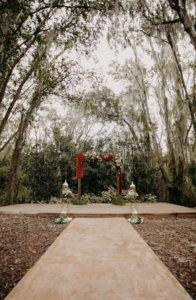 Tampa Rustic Wedding Ceremony Decor, Arch with Lush Floral Arrangements and Tall Candle Lanterns | Plant City Wedding Venue Florida Rustic Barn Weddings