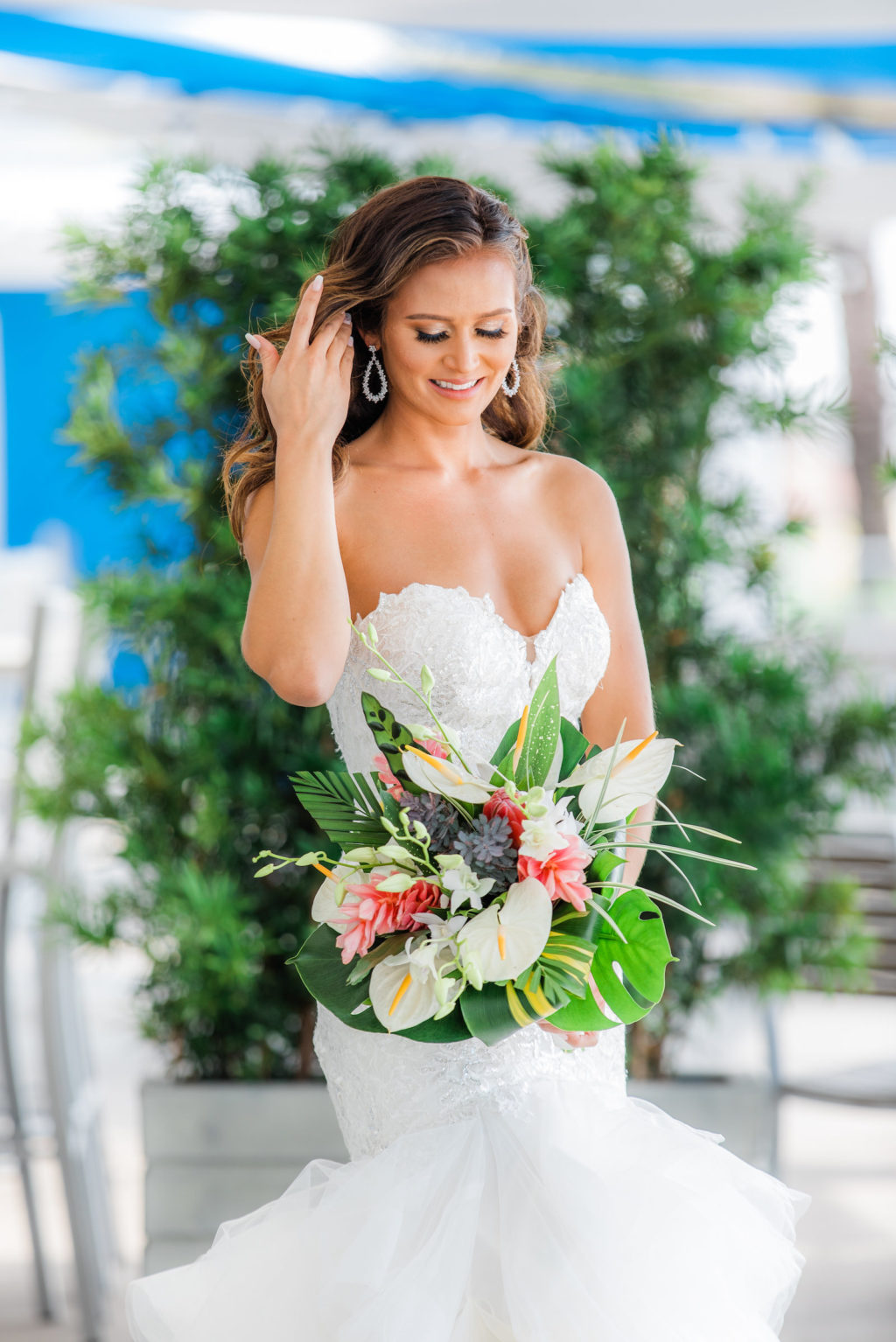 Tampa Bride in Beaded Lace Sweetheart Neckline Mermaid Wedding Dress Holding Tropical Pink Ginger, White Anthuriums, Monstera Leaves Floral Bouquet | Wedding Florist Iza's Flowers