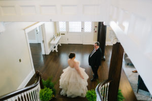 Tampa Bay Bride in Ruffle Tulle Skirt Wedding Dress First Look with Father at Bottom of Stairs in Wedding Venue The Orlo