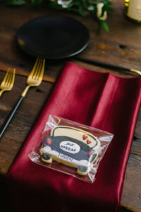 Red Napkin Wedding Reception Decor with Wooden Farm Table, Black China Tableware and Custom Cookie Favor