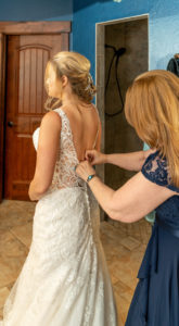 DIY Bride Putting on Lace Open Back Wedding Dress