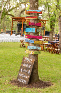 DIY Backyard Tampa Bay Wedding Reception Decor, Colorful Directional Wooden Signs on Tree