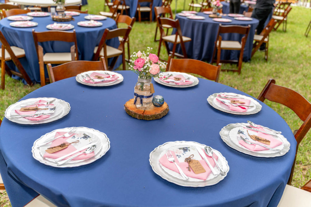 DIY Intimate Backyard Wedding Reception Decor, Round Tables with Navy Blue Table Linens, Blush Pink Napkins, Wooden Tray Centerpiece with Mason Jar, Pink Roses and White Baby's Breathe, Silver Chargers