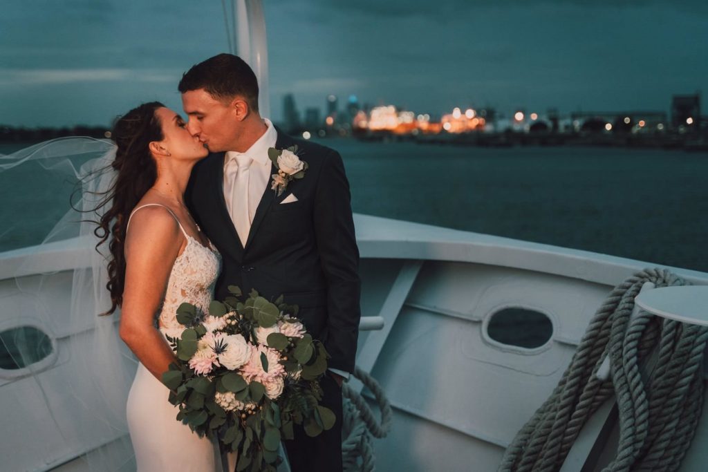 Romantic Minimalistic Bride with Full Length Veil Holding Eucalyptus Greenery, White and Pink Floral Bouquet, Groom in Navy Blue Suit and Pink Ti | Tampa Bay Waterfront Wedding Venue Yacht StarShip | Wedding Photographer and Videographer Bonnie Newman Creative | Wedding Hair and Makeup Femme Akoi Beauty Studio