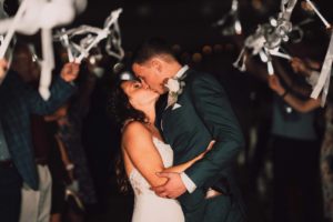 Romantic Bride and Groom Kissing During Wedding Reception Silver Streamer Wands Exit | Tampa Bay Wedding Photographer and Videographer Bonnie Newman Creative