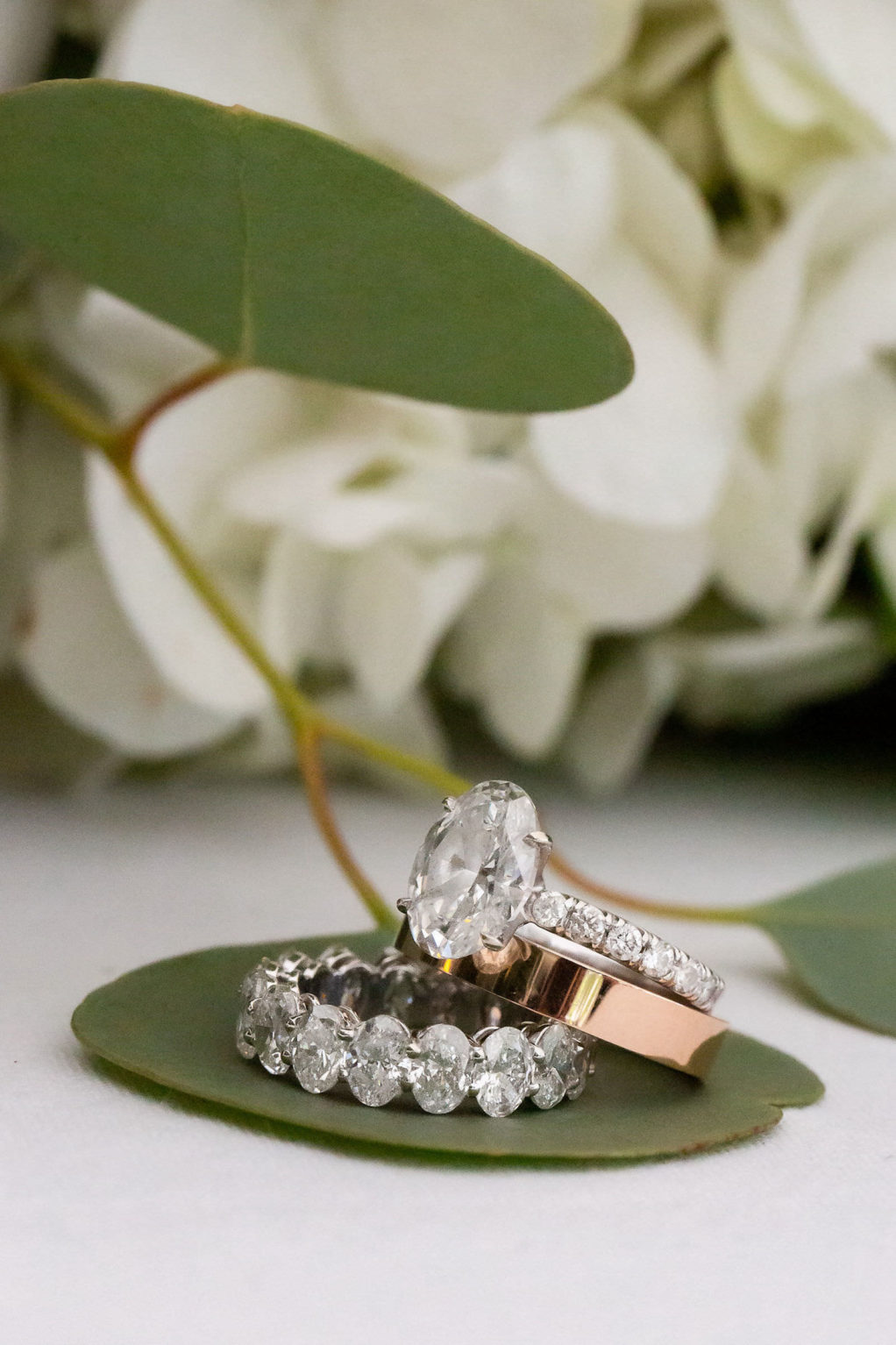 Wedding Ring Shot | Oval Solitaire Diamond Engagement Ring with Channel Set Diamond Band and Rose Gold Polished Band