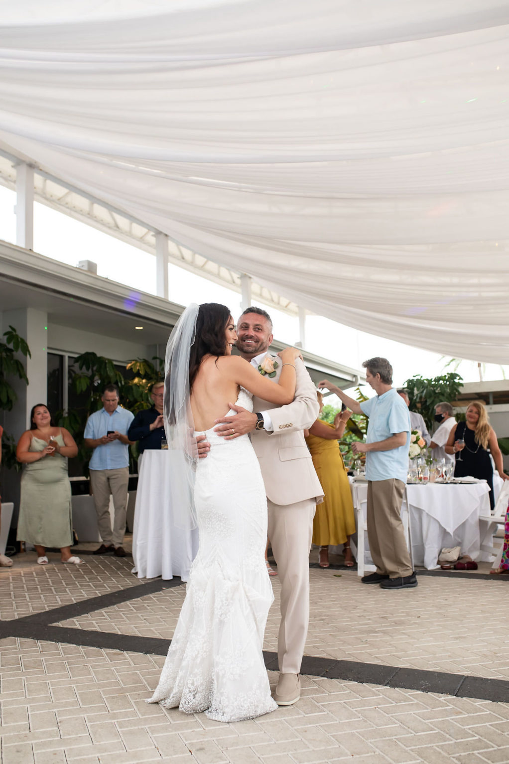 Outdoor Bride and Groom First Dance Portrait at Florida Beach Wedding at Sarasota Wedding Venue The Resort at Longboat Key Club | Bride Wearing Strapless Sheath Wedding Gown by Tara Keilly | Groom Wearing Casual Khaki Suit