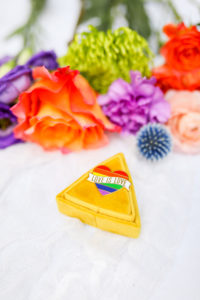 Gay LGBTQ+ Pride Wedding, Yellow Ring Box with Love is Love Rainbow Pin, Red, Purple, Green Flowers