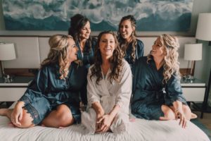 Bridal Party Getting Wedding Ready on Hotel Bed, Bridesmaids in Blue Robes | Tampa Bay Wedding Photographer Bonnie Newman Creative | Hair and Makeup Femme Akoi Beauty Studio