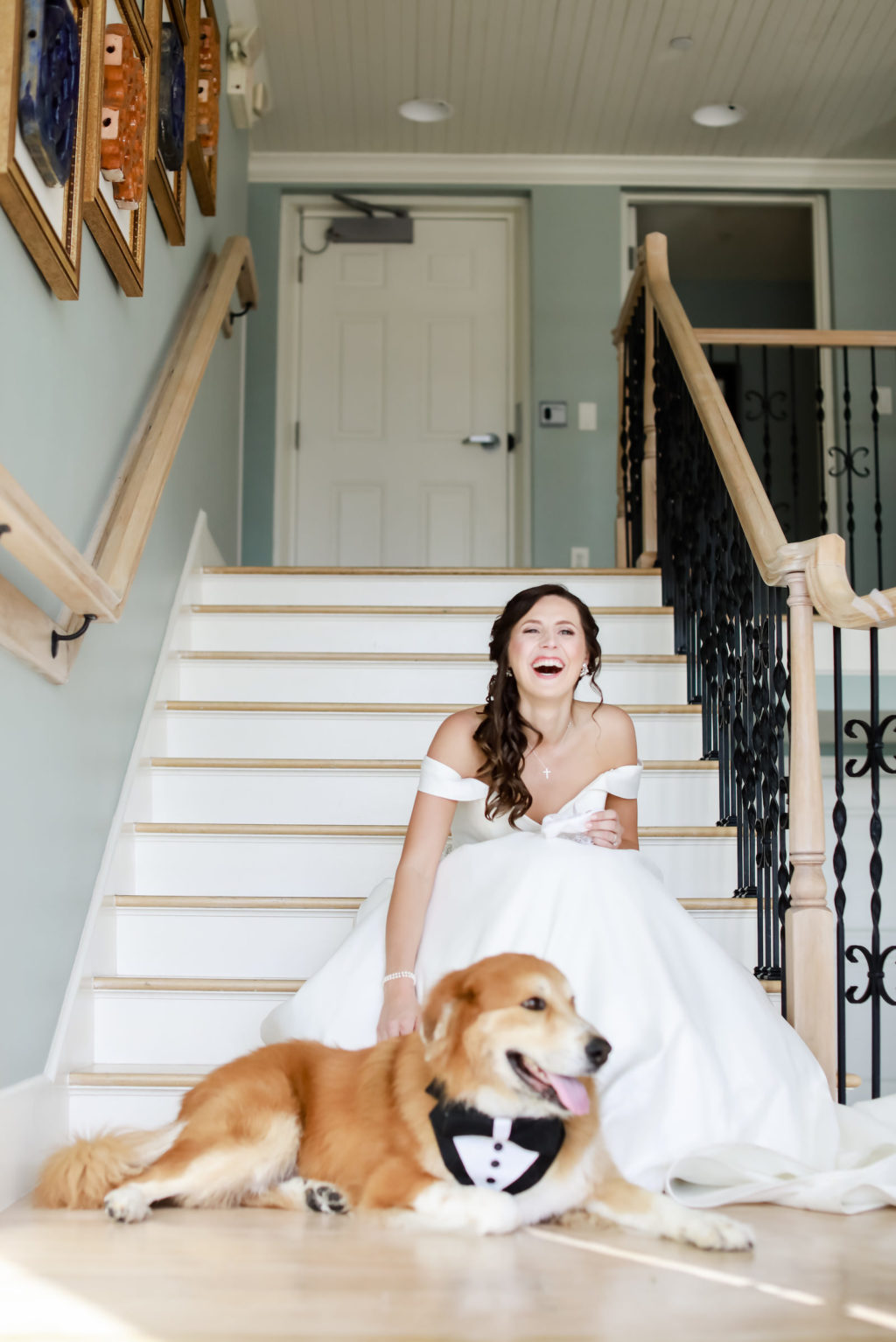 Elegant Classic Bride on Staircase Wearing Off the Shoulder Wedding Dress with Dog in Tuxedo | Tampa Bay Wedding Photographer Lifelong Photography Studio | Clearwater Beach Pet Planner FairyTail Pet Care | Wedding Hair and Makeup Adore Bridal