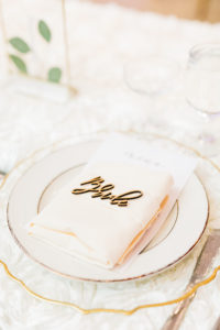 Elegant Garden Wedding Reception Decor, Long Feasting Table with White Floral Table Linen, Scalloped Gold and Clear Charger, Blush Pink Linen Napkin, Laser Cut Name Place Card | Tampa Bay Wedding Rentals Kate Ryan Event Rentals