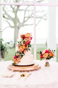 Elegant Three Tier White Wedding Cake with Vibrant Cascading Pink, Orange and Greenery Flowers | Tampa Bay Florist Monarch Events and Design
