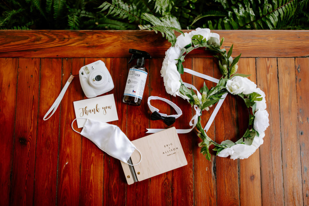 Garden Inspired Florida Wedding Details, White Flower Crowns, Modern Wooden Engraved Guest PhotoBook with White Polaroid Camera Snapshots, White Masks and Handed Sanitizer For Pandemic Safe Wedding, Bowtie Dog Collar | Tampa Bay Luxury Wedding Planner Parties A'La Carte