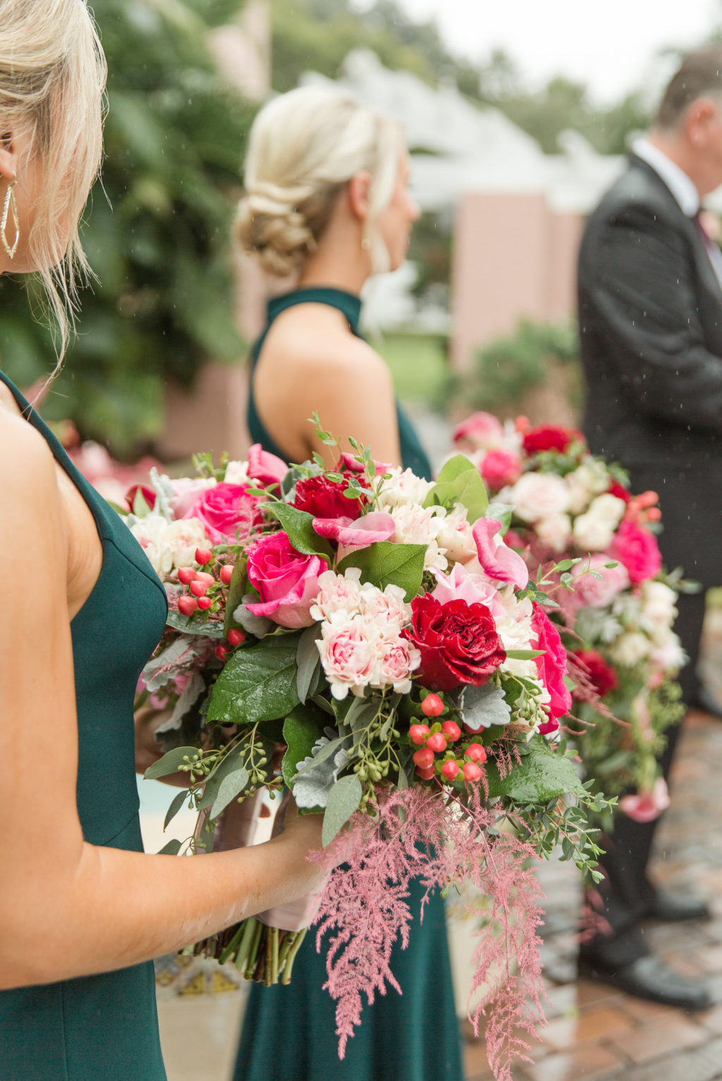 Bridesmaids in Emerald Green Dresses Holding Pink, Red Roses and Berries Floral Bouquet with Greenery Lush Floral Bouquet
