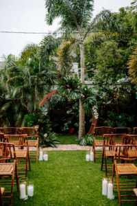 Outdoor Florida Wedding, Backyard Ceremony with Jungle Inspired Decor with Bamboo Circle Arch and Folding Chair Rentals, Bright Greenery with pops of Pink Florals and White Orchids | St. Petersburg Wedding Planner Parties A'La Carte