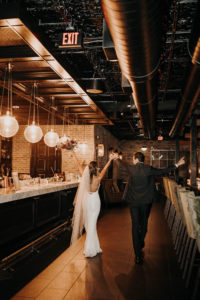 Florida Bride and Groom Hands Up in Air After Getting Married | Wedding Venue Urban Stillhouse St. Pete