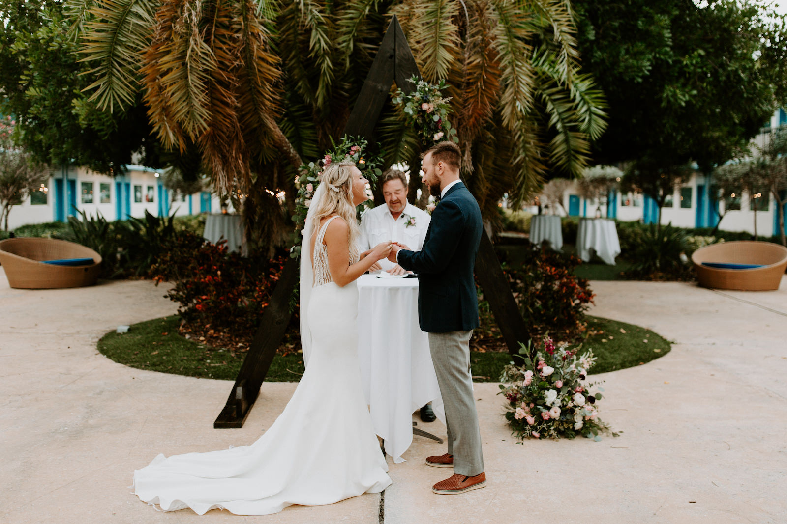 Tropical Garden Bride and Groom Exchanging Wedding Vows During Outdoor Wedding Ceremony | St. Pete Wedding Venue Postcard Inn