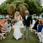 Tropical Garden Bride and Groom Exiting Wedding Ceremony | St. Pete Wedding Venue Postcard Inn
