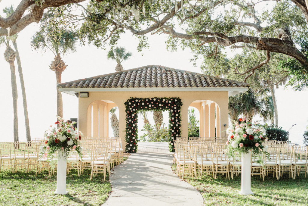 Romantic Timeless Wedding Ceremony Decor, Gazebo with Lush Greenery and Floral Arch, Burgundy, Blush Pink and White Flowers on White Pedestals | Tampa Bay Wedding Photographer Dewitt for Love Photography | Sarasota Wedding Venue Powel Crosley Estate