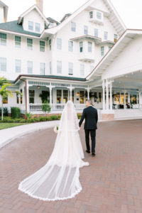 Classic Florida Bride and Groom Outside Belleview Inn, Long Cathedral Length Galia Lahav Bridal Veil | Tampa Bay Wedding Planner Parties A'La Carte | South Tampa Wedding Dress Boutique Isabel O'Neil Bridal Collection