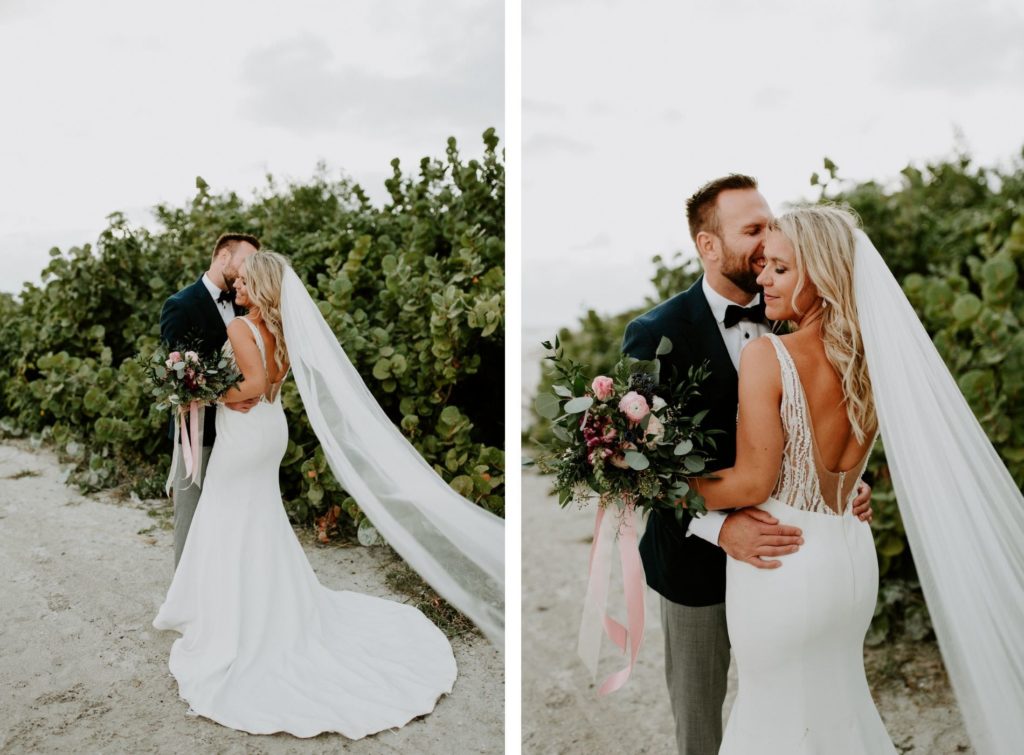 Florida Bride in Fitted Lace and Illusion Plunging V Open Back Wedding Dress and Full Length Veil Holding Wild Greenery Eucalyptus with Pink and Purple Floral Bouquet, Groom in Emerald Green Tuxedo Jacket and Bowtie | St. Pete Wedding Venue Postcard Inn on the Beach