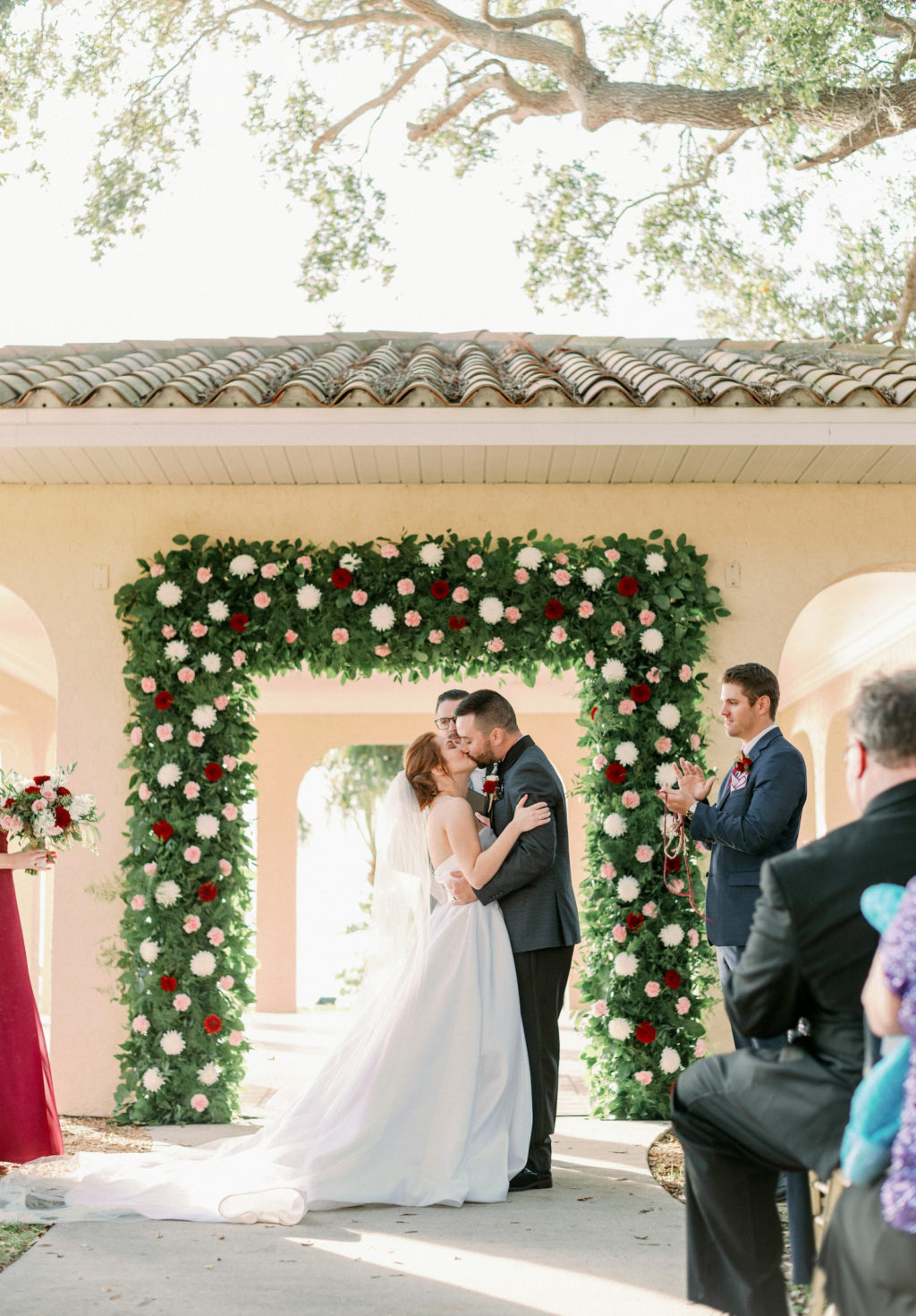 Timeless Romantic Bride and Groom Exchanging Wedding Vows at Gazebo with Greenery Burgundy Red, Blush Pink and White Floral Arch | Tampa Bay Wedding Photographer Dewitt for Love Photography | Sarasota Wedding Venue Powel Crosley Estate