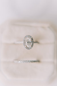 Oval with Halo Diamond Engagement Ring and Thin Diamond Wedding Band in Ivory Velvet Ring Box