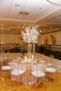 Luxurious Clearwater Ballroom Wedding Reception and Decor, Round Tables with Champagne Linens, Large Floral Centerpieces with Cherry Blossoms, White Hydrangeas, Pink Roses, Ivory Roses, Candlelight, Ghost Chiavari Chairs, Cocktail Hour Band, Belleair Country Club | Florida Wedding Planner Parties A'La Carte | Tampa Bay Wedding Florist Clearwater | Rentals A Chair Affair