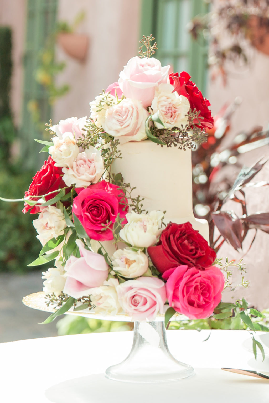 Elegant Garden Themed Wedding Reception Cake, White One Tier Wedding Cake with Blush, Hot Pink, Red and Ivory Roses Cascading Down Cake