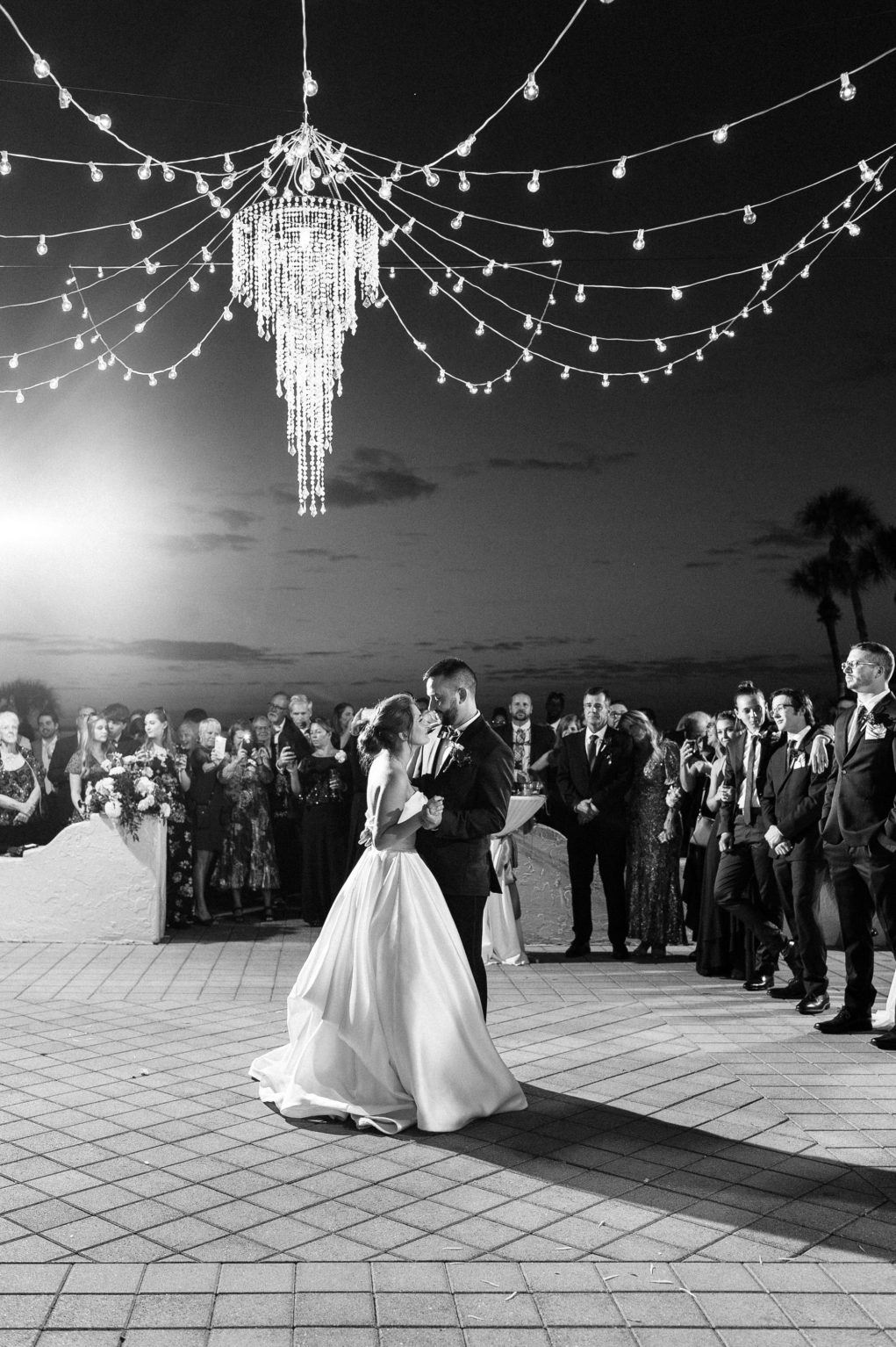 Bride and Groom Outdoor First Dance Under String Lights and Chandelier | Tampa Bay Wedding Photographer Dewitt for Love Photography | Sarasota Wedding Venue Powel Crosley Estate