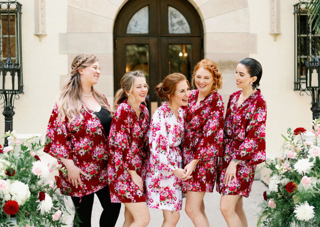 Bride and Bridesmaids in Matching Red and Pink Floral Robes | Tampa Bay Wedding Photographer Dewitt for Love Photography