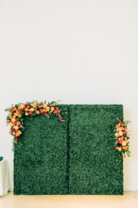 Garden Wedding Reception Decor, Greenery Hedge Backdrop with Vibrant Colorful Pink, Orange Lush Floral Arrangements | Tampa Bay Wedding Florist Monarch Events and Design | Wedding Rentals Kate Ryan Event Rentals