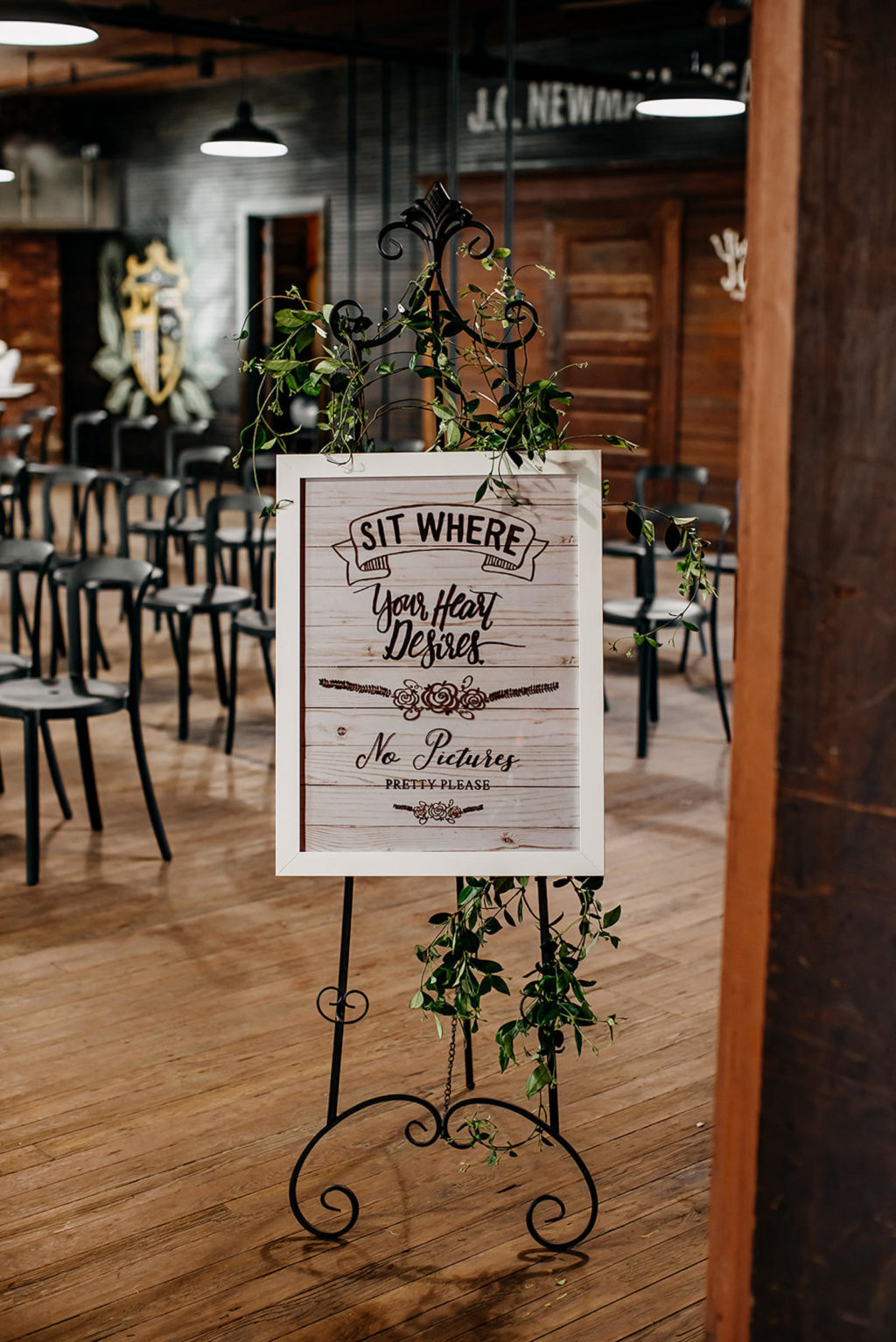 Vintage Inspired Tampa Bay Wedding Ceremony Decor, Wooden Welcome and No Cell Phone Ceremony Sign Sit Where Your Hear Desires No Pictures Please, Industrial venue decorated with Cascading Greenery, Ivy and Vines Wrapped Around Staircase | Unique Florida Wedding Venue J.C. Newman Cigar Co. in Ybor City