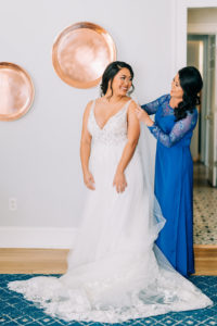 Tampa Bay Bride Getting Wedding Ready with Mom in Lace V Neckline with Straps Bodice and Tulle A-Line Skirt with Full Length Veil