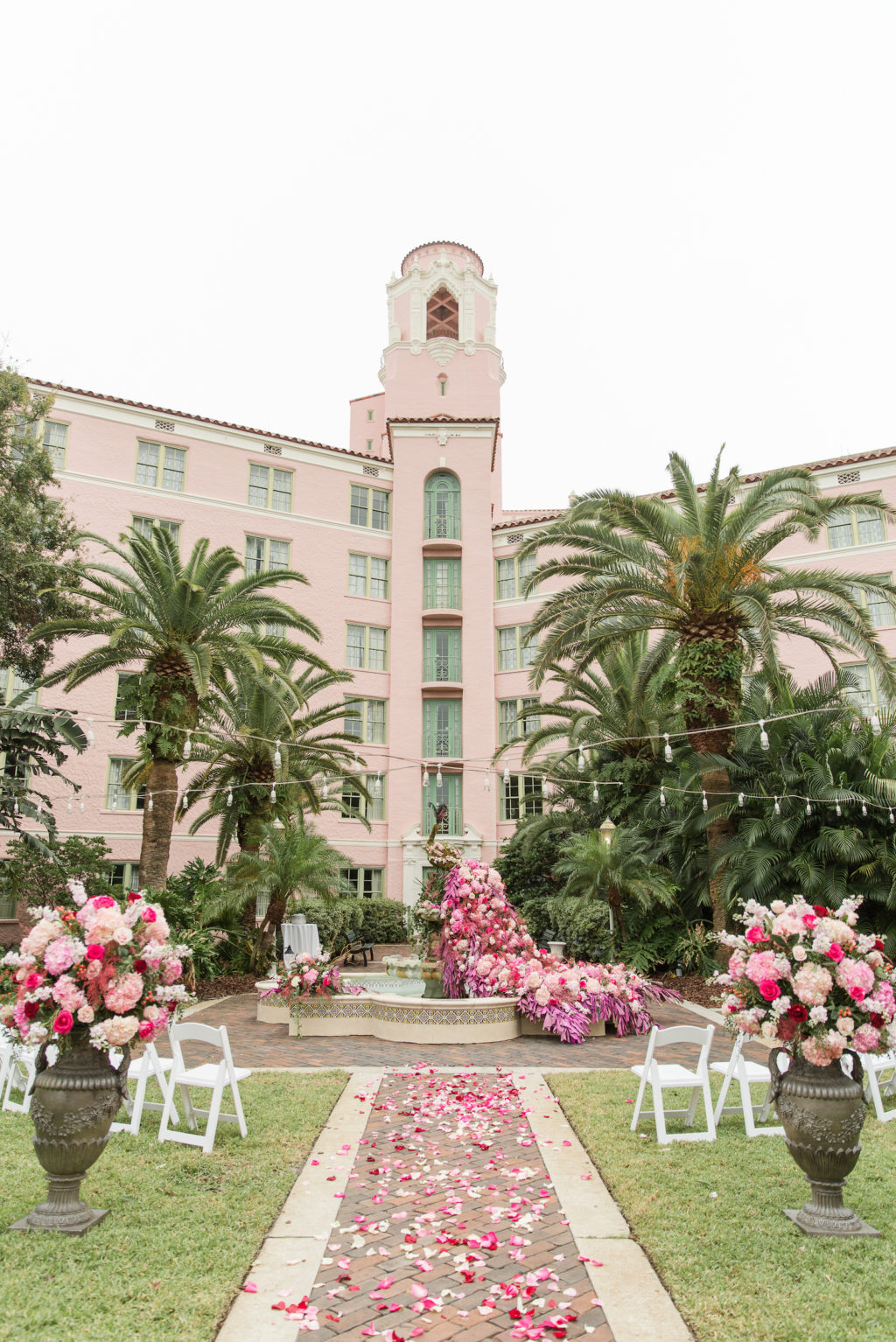 Elegant Garden Themed Wedding Ceremony Decor, Lush Pink and Purple Flowers in Water Fountain and Floral Arrangements, String Lights | St. Pete Wedding Venue The Vinoy Renaissance