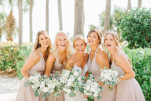 Natural Classic Bride in Romantic Spaghetti Strap Lace Wedding Dress and Bridesmaids in Dusty Rose, Mauve Dresses Holding White Roses and Eucalyptus Greenery Floral Bouquets