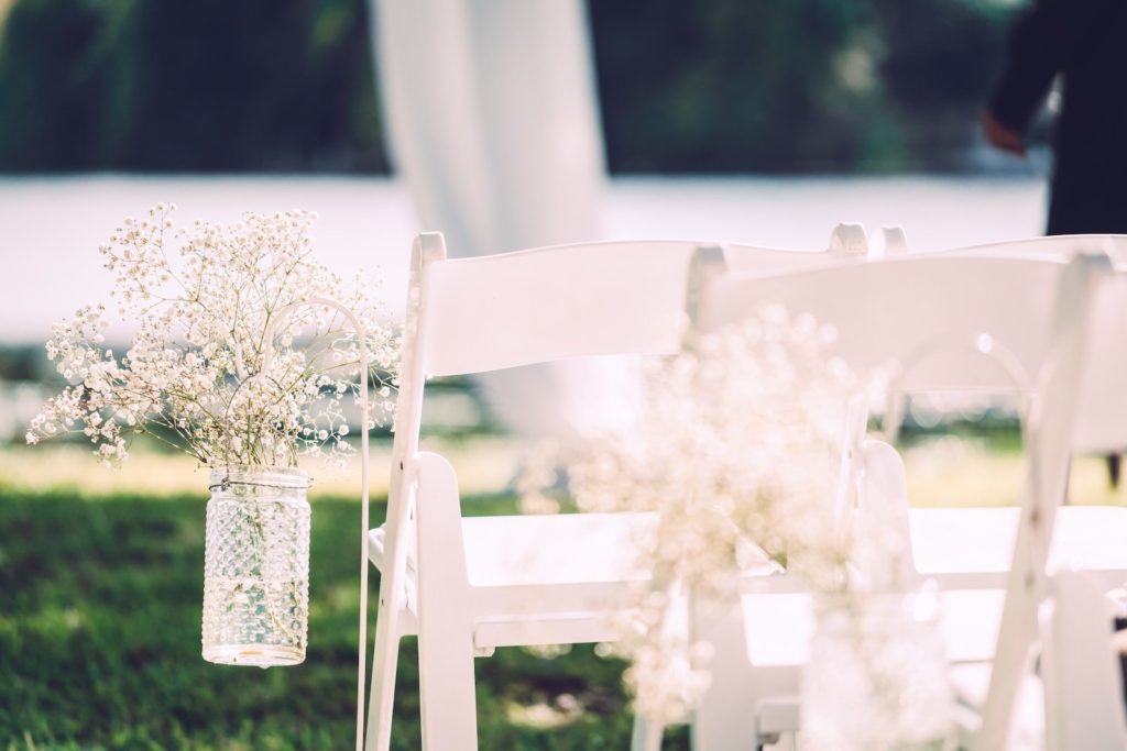 Shappy Chic Wedding Ceremony Decor, White Folding Chairs with Baby's Breathe in Mason Jars Floral Arrangements on Chairs | Tampa Bay Wedding Photographer Bonnie Newman Creative