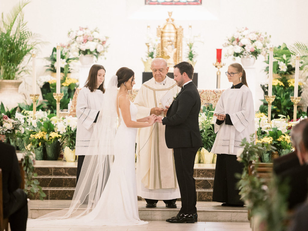 Traditional Bride and Groom Exchanging Wedding Vows During Ceremony | Tampa Wedding Venue Christ the King Catholic Church