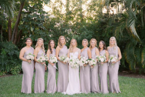 Classic Florida Bride and Bridesmaids in Earthy Gray One Shoulder Matching Dresses Holding White Floral Bouquets