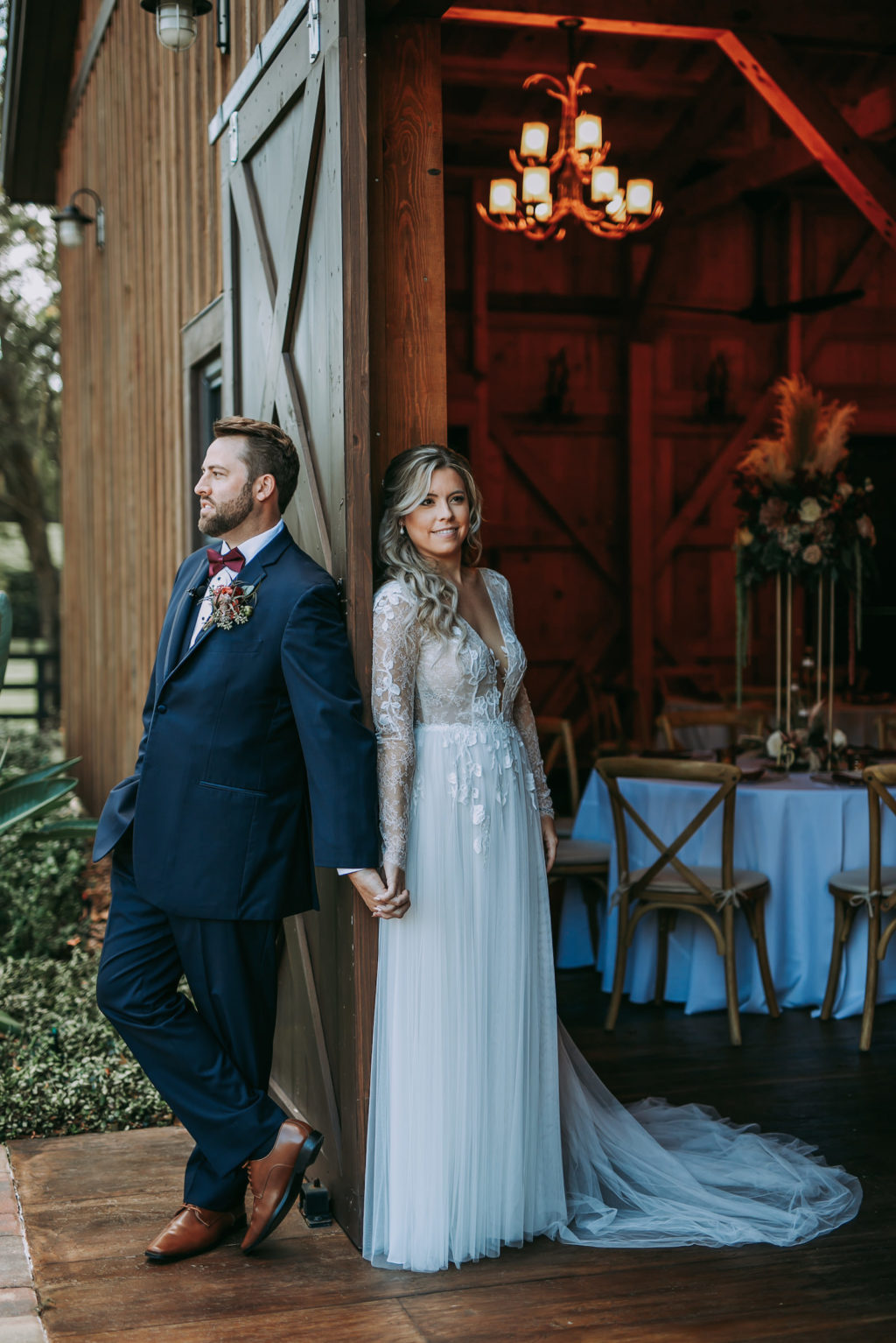 Rustic Florida Bride and Groom Holding Hands Back to Back Behind Barn Door | Tampa Wedding Venue Mision Lago Estate