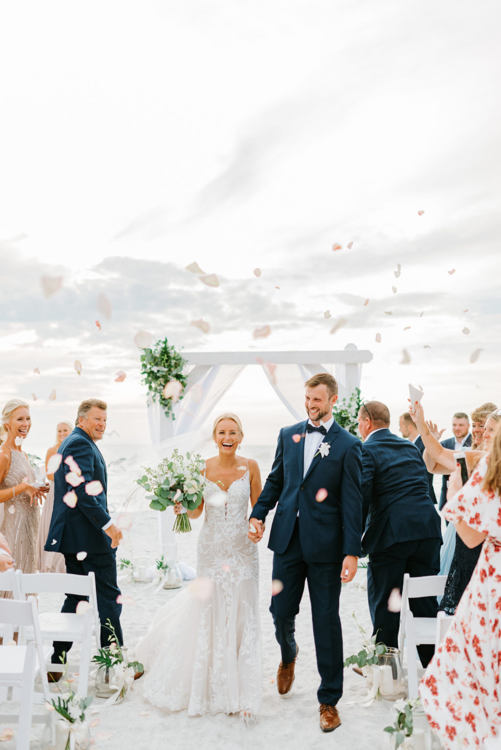 Florida Bride and Groom Exiting Wedding Ceremony on Beach, Guests Throwing Flower Petals | Tampa Wedding Venue The Resort at Longboat Key Club